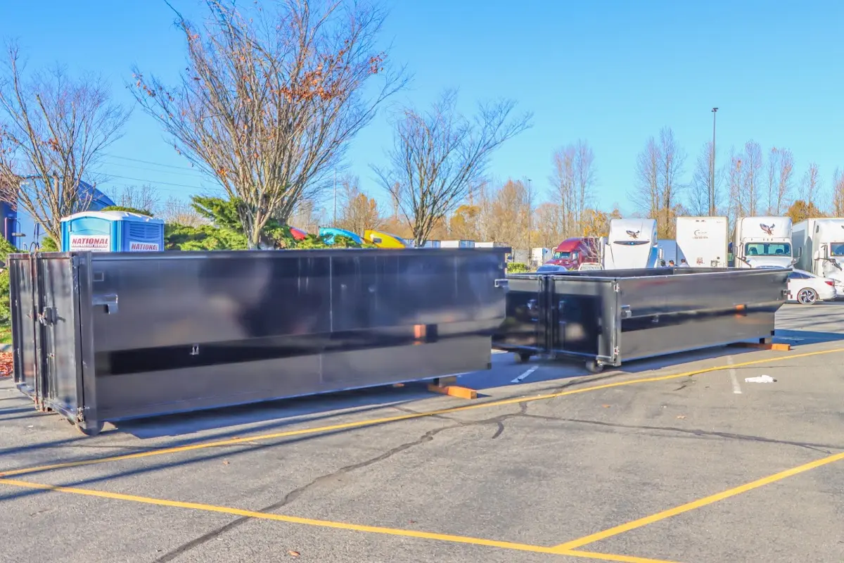 Professional dumpster rental service with roll-off container on residential driveway in Carney